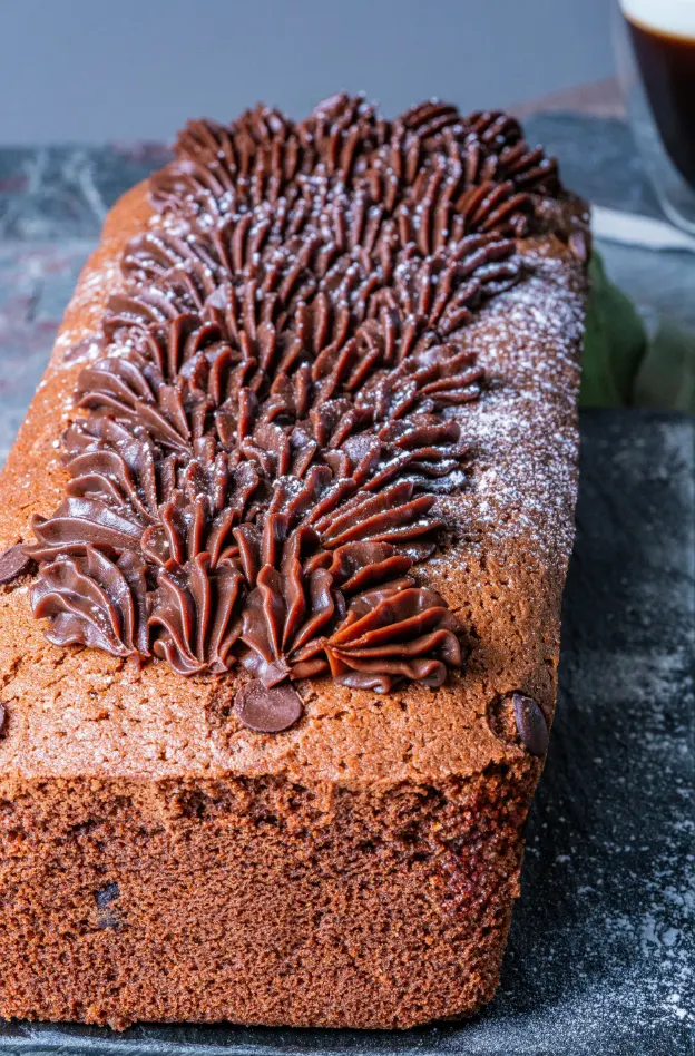 Rich chocolate pound cake sliced to show the dense, dark cocoa crumb
