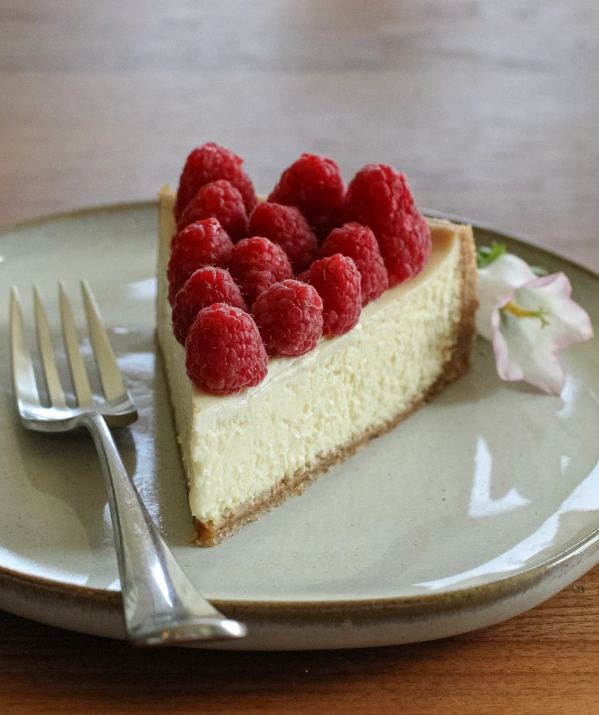 Classic Philadelphia cheesecake slice showing the smooth, dense cream cheese filling