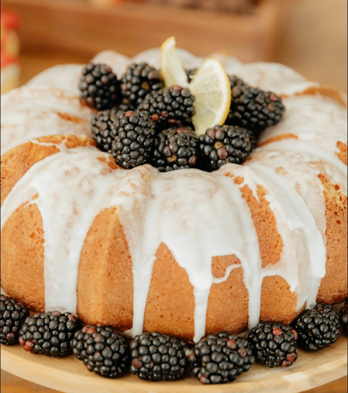 Classic vanilla bundt cake with glaze drizzled over the ridged ring