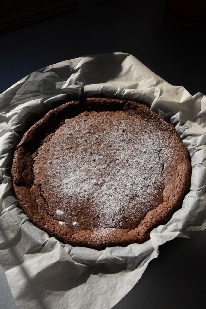 Cracked chocolate cake dusted with powdered sugar