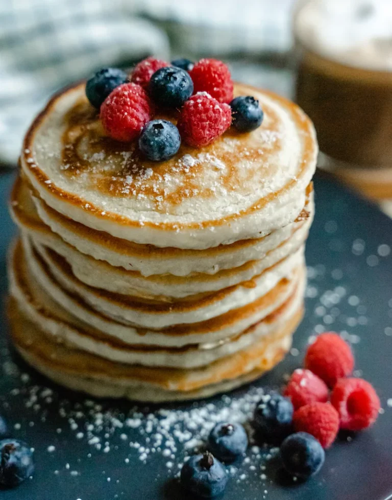 Stack of fluffy American pancakes with butter and maple syrup