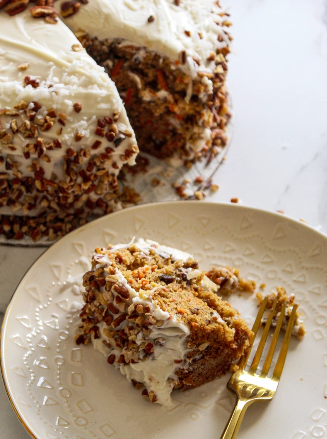 Slice of hummingbird cake with cream cheese frosting