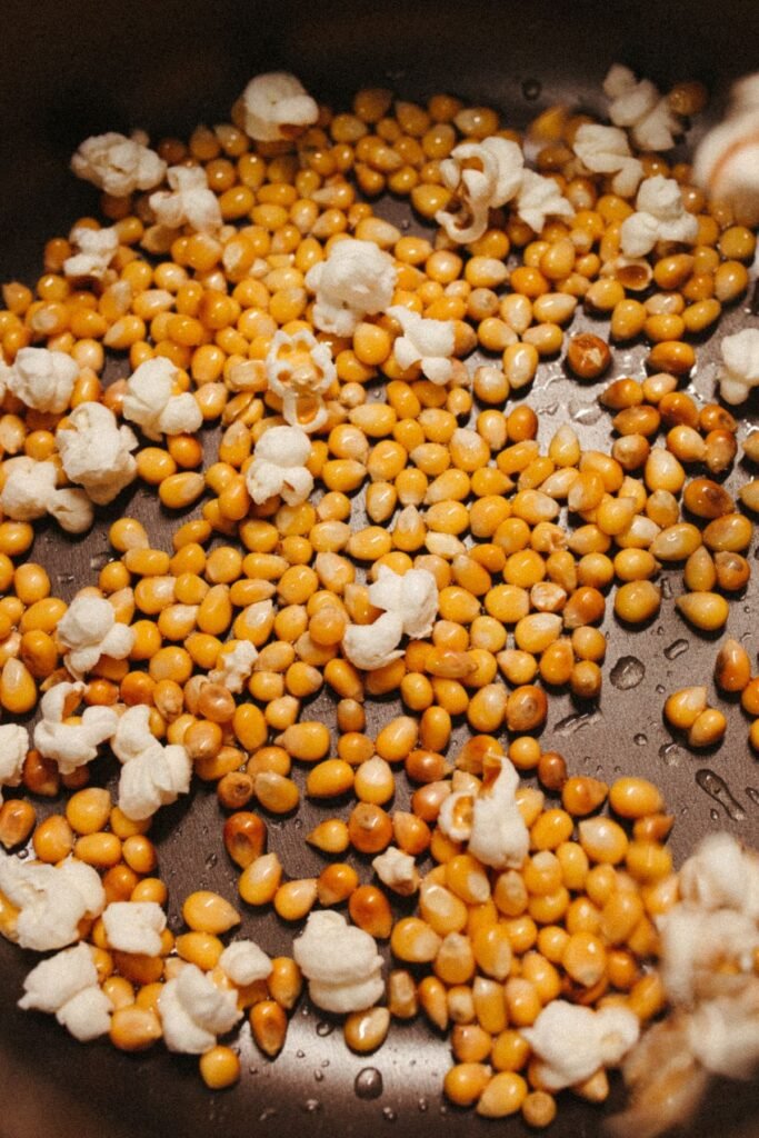 Popcorn kernels popping in a pan