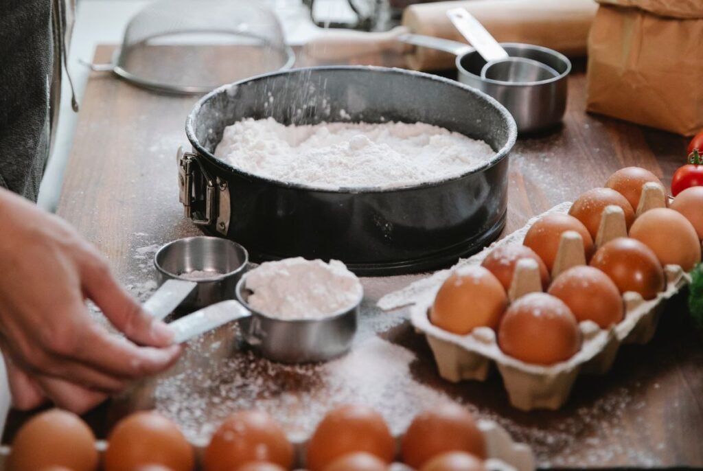 Measuring and sifting flour into a cake pan