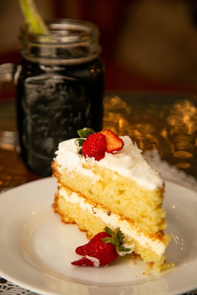 Slice of soaked tres leches cake showing moist layers