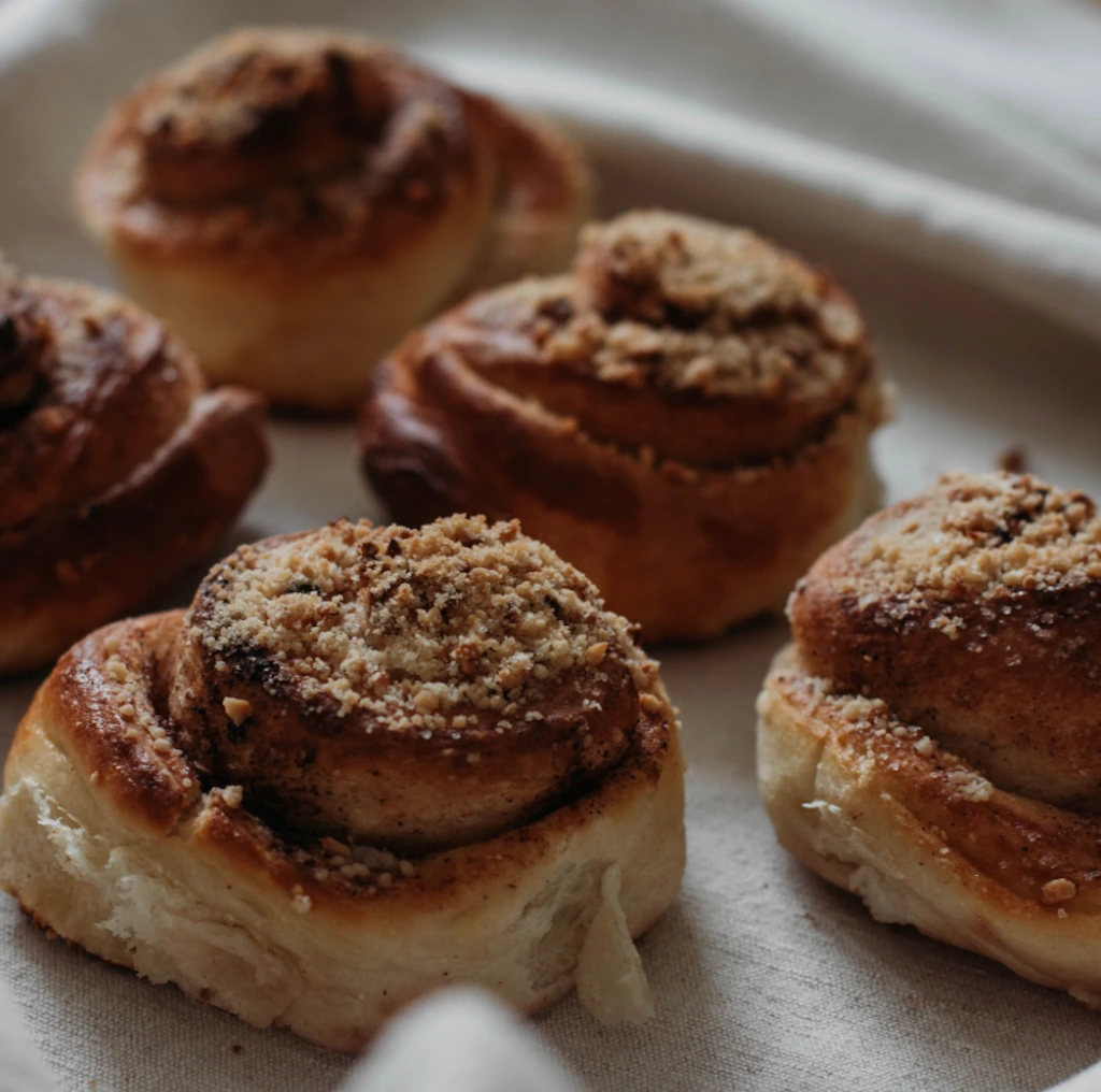 Swedish cardamom buns in a knot shape dusted with pearl sugar