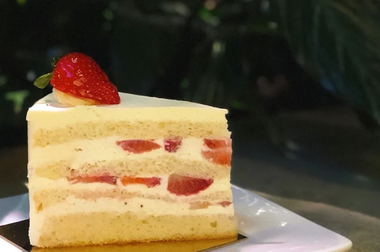 Classic Victoria sponge cake filled with jam and cream, dusted with icing sugar